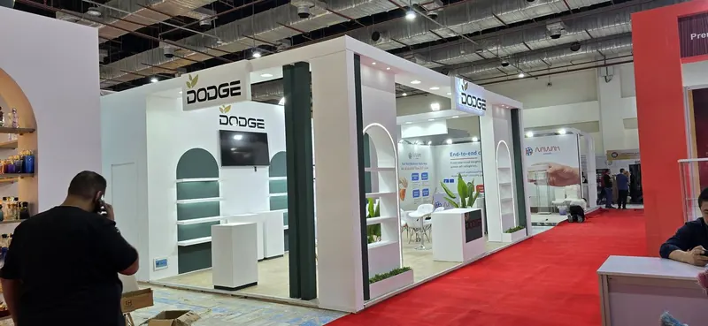 Dodge — A clean, arched stand for a hair-care and cosmetics brand, with display shelving.