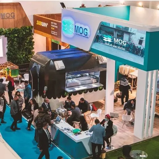 MOG — An open stand for an industrial group, with hospitality areas and greenery.