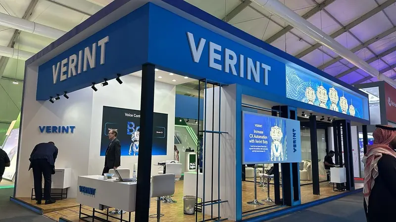 Verint — A stand for a global software and analytics company, with an open front and a demo area.